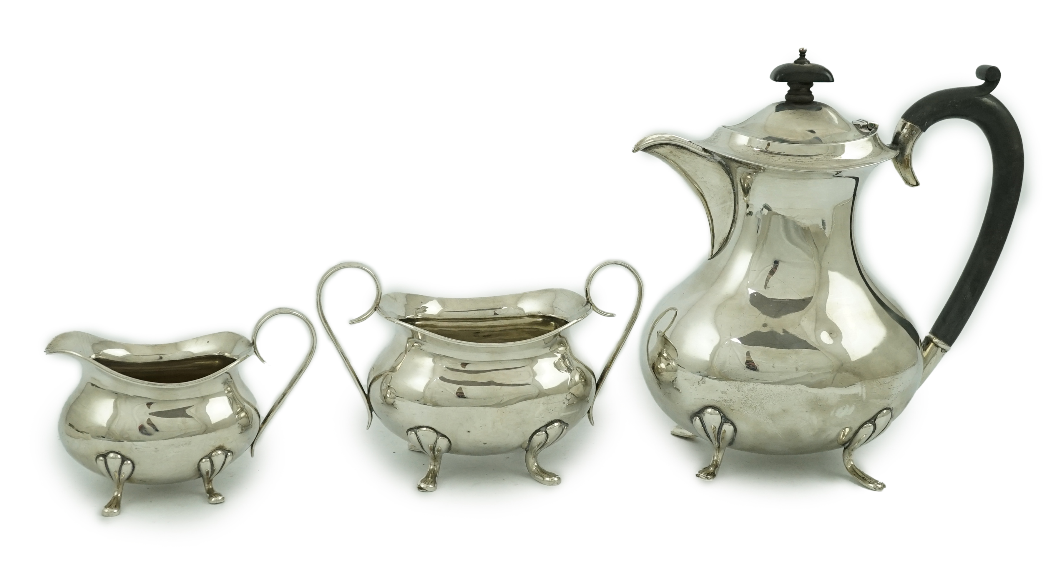 A George V matched silver three piece tea set by Joseph Gloster Ltd